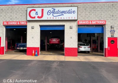 Auto repair shop storefront of C&J Automotive S& Tire of Lansdale showing service bays for oil changes, tires, brakes, and batteries.
