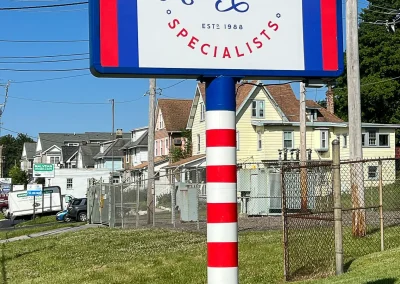 Close-up shot of the C&J Automotive & Tire Specialists of Berwyn storefront sign.