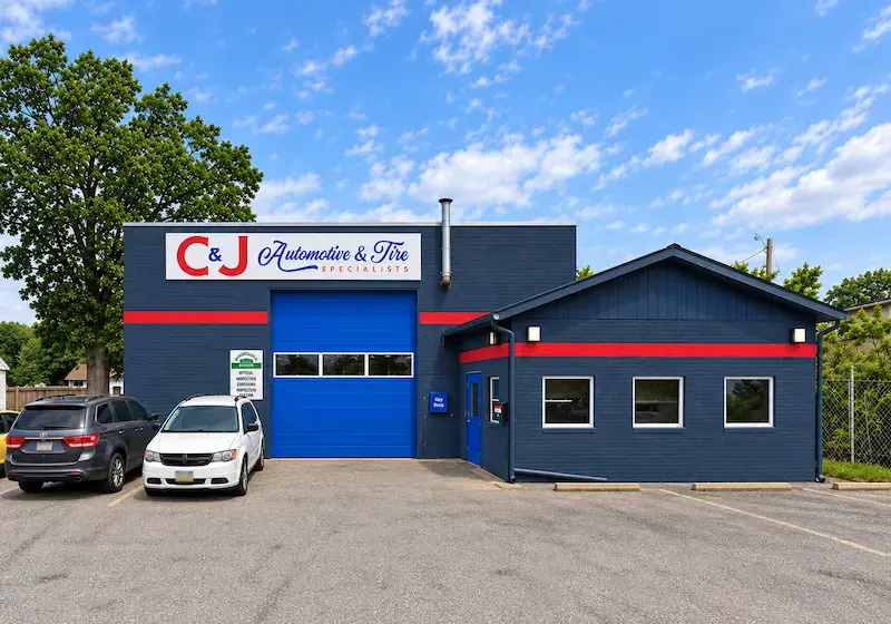 Exterior of C&J Auto in Hammonton showing the used car sales office and auto repair shop with open bays for oil changes, alignment, brakes and batteries, and tires and tune-ups.